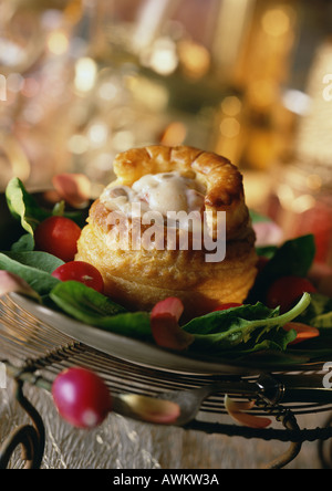 Vol-au-vent (la pâtisserie française avec remplissage), sur lit de légumes verts, close-up Banque D'Images