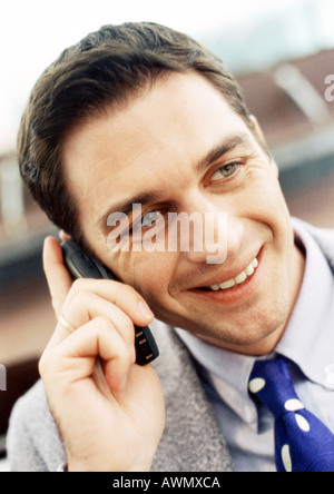 Businessman using cellular phone, close-up, portrait. Banque D'Images