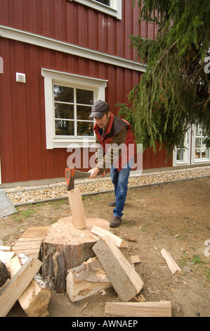 Man chopping wood à maison, Großbeeren, Brandenburg, Allemagne Banque D'Images