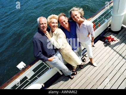 Les couples d'âge mûr se tenait à côté de balustrade de bateau, portrait, high angle view Banque D'Images