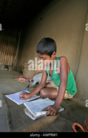 BANGLADESH 11 ans Homar Ritchil faisant ses devoirs scolaires Banque D'Images