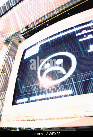 Ordinateur avec visage frowny, digital composite Banque D'Images