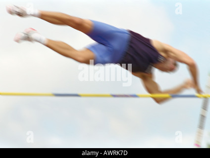 Athlète masculin à la mi-air, low angle view, blurred motion Banque D'Images
