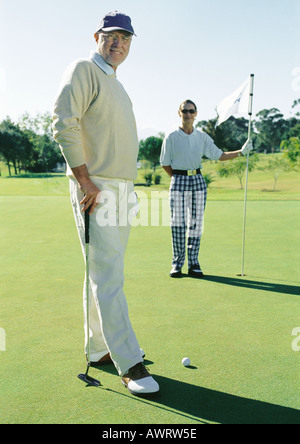 Deux golfeurs mature sur vert, portrait Banque D'Images