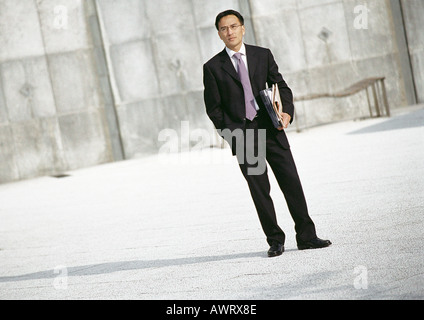 Businessman standing outdoors, portrait Banque D'Images