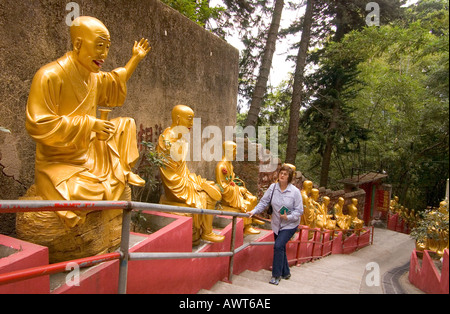dh dix mille Monastère Bouddhas SHATIN HONG KONG femme touriste Marche en haut des marches statues de Bouddha d'or 10000 temple chemin chine Banque D'Images