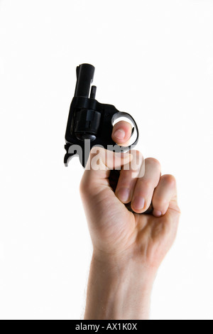 Studio shot of a human hand holding a coup de canon Banque D'Images