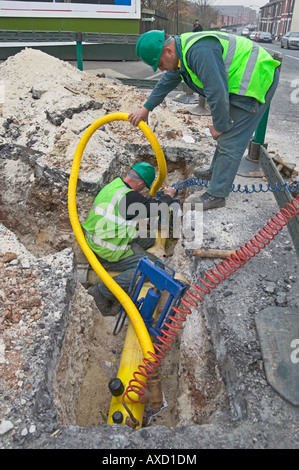 La réhabilitation d'une ville, l'approvisionnement en gaz naturel en remplaçant la détérioration des tuyaux en fonte victorienne avec tube polyéthylène moderne. Banque D'Images