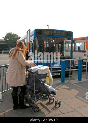 Femme avec son enfant dans une poussette bus Stagecoach en attente à la gare routière de Chichester, West Sussex Banque D'Images