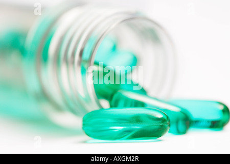 Green Pills Spilling Out of Bottle Banque D'Images