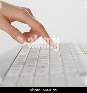 Close up of woman s doigt sur un clavier d'ordinateur Banque D'Images