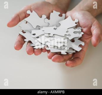 Hands holding puzzle pieces Banque D'Images