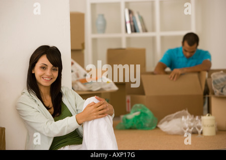 Jeune couple unpacking boxes in new house Banque D'Images