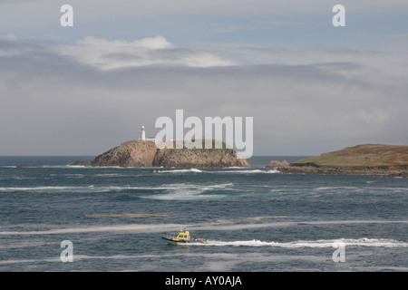 Un petit bateau traverse l'eau agitée entre St Martin et Tresco Banque D'Images