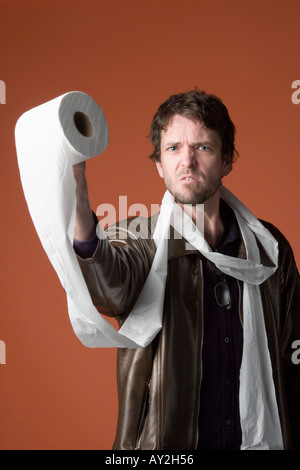 Young Caucasian man enveloppé dans du papier de toilette Banque D'Images