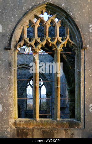 Voir à travers un glassless fenêtre cintrée d'une église à l'abandon par des pyromanes brûlé et laissé comme une ruine Banque D'Images