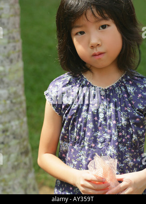 Portrait d'une jeune fille près d'un tronc d'arbre Banque D'Images