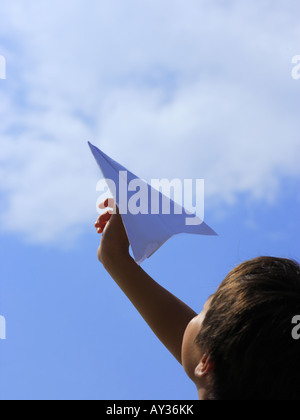 Low angle view of a Boy holding a paper airplane Banque D'Images