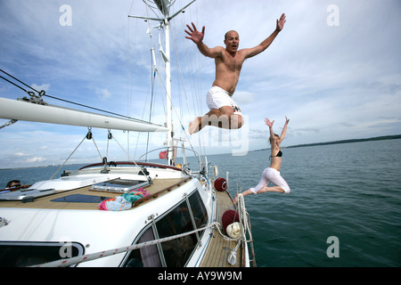 Couple sauter de yacht à voile, Cowes, île de Wight, Royaume-Uni Banque D'Images