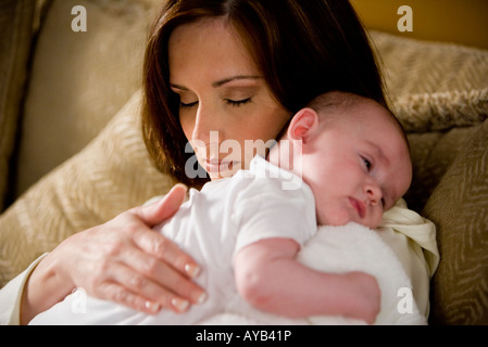 Close-up of a sleeping mère tenant un bébé à dormir sur ses épaules Banque D'Images