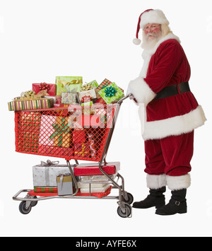 Santa Claus pushing shopping cart full of gifts Banque D'Images