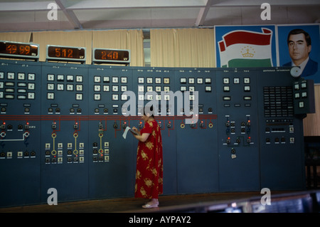 Le TADJIKISTAN en Asie centrale du panneau de nurek au hall principal de station d'énergie hydroélectrique avec femme prendre des lectures Banque D'Images