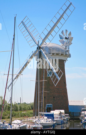 Restorted Bazin à Horsey Norfolk Angleterre montrant mill et bateaux sur la rivière avec un bleu ciel d'été Banque D'Images