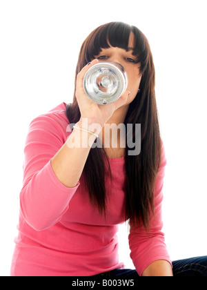 Jeune Adolescente mineurs assis sur le sol face à lui seul causé l'abus d'alcool Boire de l'alcool porte un haut rose et bleu denim Jeans Banque D'Images