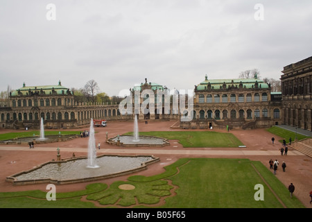 Le palais Zwinger à Dresde avec son architecture baroque, ses fontaines et ses jardins entretenus sous un ciel nuageux. Banque D'Images