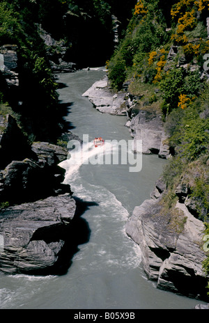 Une vue sur la gorge et un Shotover jet boat sur la rivière Shotover près de la montagne remarquable et Queenstown, Nouvelle-Zélande. Banque D'Images