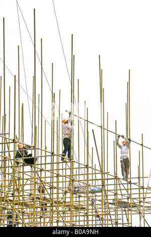 Les travailleurs de la construction sur des échafaudages, low angle view Banque D'Images