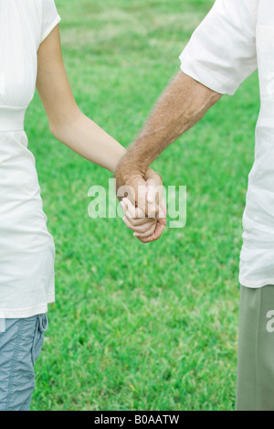 Couple holding hands outdoors, portrait Banque D'Images