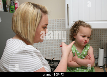 Mère lui disant tout-petit fille obstinée, le terrible twos. Banque D'Images