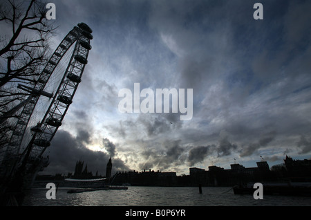 La roue du millénaire avec les Chambres du Parlement et Big Ben au coucher du soleil sur les rives de la Tamise à Londres Banque D'Images