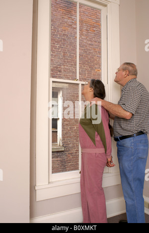 L'intérêt partagé d'intérêt 'partagé' 'couple looking out window' Banque D'Images