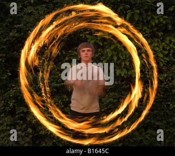 Teenage boy playing with fire personnel Banque D'Images