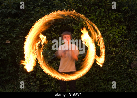 Teenage boy playing with fire personnel Banque D'Images