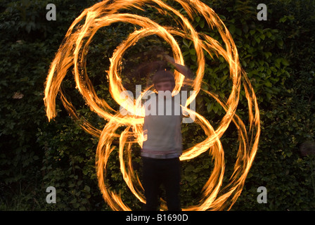 Teenage boy playing with fire personnel Banque D'Images