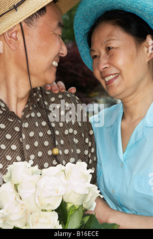 Senior Asian couple smiling at each other Banque D'Images