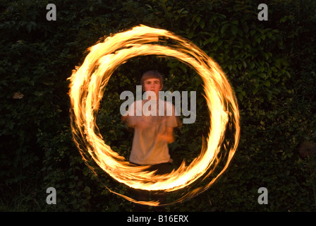 Teenage boy playing with fire personnel Banque D'Images