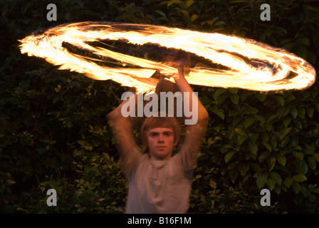 Teenage boy playing with fire personnel Banque D'Images