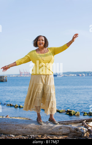 African American Woman standing on log Banque D'Images