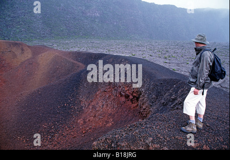 Tourist debout sur le bord du cratère Formica Leo, volcan Piton de la Fournaise, La Réunion, océan Indien Banque D'Images