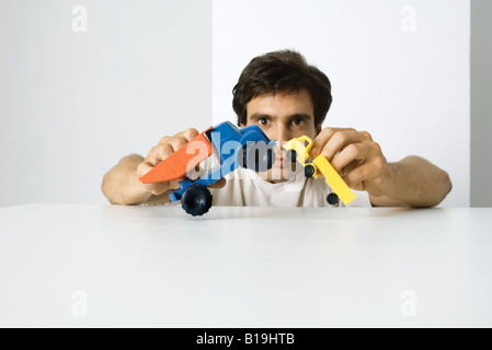 Man Playing with toy trucks Banque D'Images
