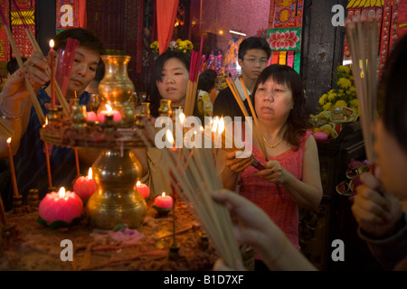 Adorateur des femmes à l'éclairage des bougies temple déesse de la Miséricorde Temple, pendant le Nouvel An chinois. Georgetown. Penang. La Malaisie. Banque D'Images