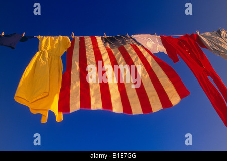 US Flag et uniformes sur la ligne de vêtements dans le vent contre le ciel bleu USA Banque D'Images