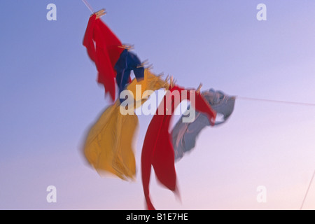 US Flag et uniformes sur la ligne de vêtements dans le vent contre le ciel bleu USA Banque D'Images