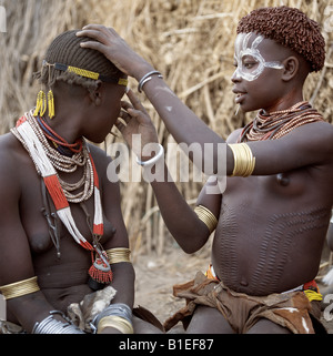 Karo pour peindre le visage en préparation d'une danse. C'est une tradition pour les filles à percer un trou en dessous de la lèvre inférieure. Banque D'Images