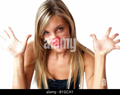 Close-up portrait of a young woman wearing clown nose Banque D'Images