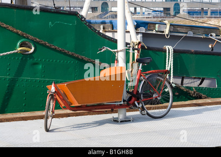 L'opérateur Orange bike stationné au quai à côté de péniche. Banque D'Images